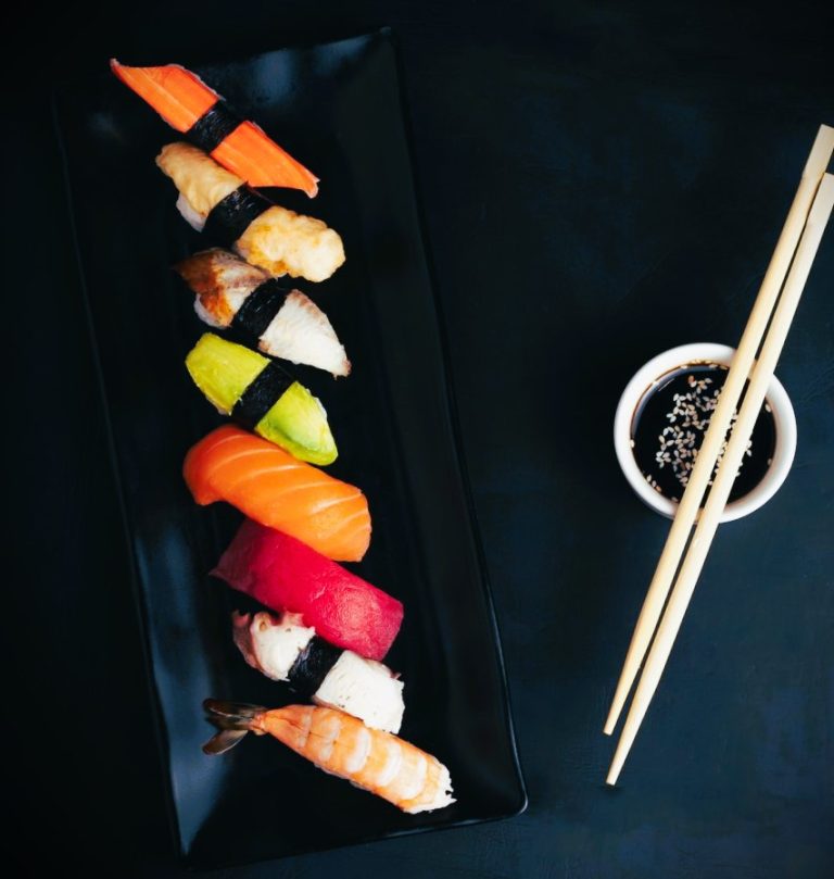 Sushi on a black plate.